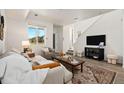 Cozy living area with large window, neutral tones, and stylish furnishings at 23527 E 5Th Pl, Aurora, CO 80018