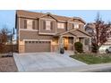 Two-story house with a large front yard, attached garage, and basketball court at 10918 Bellbrook Cir, Highlands Ranch, CO 80130