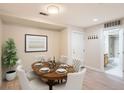 Dining room featuring an oval table with seating for six and adjacent bathroom at 5201 S Fox St # 102, Littleton, CO 80120