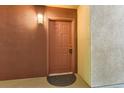Close-up of a unit front door with visible unit number and a simple welcome mat at 5201 S Fox St # 102, Littleton, CO 80120
