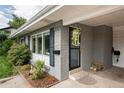 Inviting front entrance with gray brick exterior and landscaping at 5080 S Inca Dr, Englewood, CO 80110