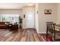 Inviting foyer with wood floors, decorative door, and view to living room at 6222 Kilmer Loop # 103, Golden, CO 80403