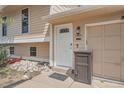A close up front exterior featuring the front door, packages box, and house number at 15691 E Atlantic Cir, Aurora, CO 80013