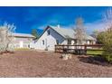 A backyard view showcasing the house, a wooden fence, and wood chip ground cover at 4087 S Clarkson S St, Englewood, CO 80113