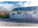View of the back of the house showing the back door and a gravel yard at 4087 S Clarkson S St, Englewood, CO 80113