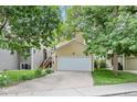 Inviting exterior view of the home with a well-kept lawn and attached two-car garage at 76 Mineola Ct, Boulder, CO 80303