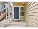 Charming front entrance featuring a gray door with a window and a cozy covered porch at 76 Mineola Ct, Boulder, CO 80303