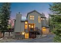 Charming home boasts a craftsman style design and inviting curb appeal with mature trees and mountain views at 293 Settlers Dr, Breckenridge, CO 80424