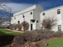 Exterior of townhome with vinyl siding, manicured lawn, and decorative bushes at 11113 E Alameda # 207, Aurora, CO 80012