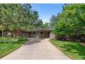 Well-maintained brick home with mature trees and a long driveway at 2717 S Langley Ct, Denver, CO 80210