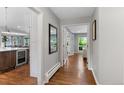 Hallway featuring hardwood floors and views into the kitchen and living spaces at 2717 S Langley Ct, Denver, CO 80210