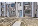 Multi-story townhouse with a mix of brick and stone facade, showcasing a contemporary design and individual entryways at 352 N. Geneva St, Aurora, CO 80010