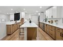 Spacious kitchen with a long quartz island, stainless steel appliances, and sleek, modern cabinetry at 11351 Quivas Way, Denver, CO 80234