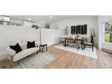 Bright living room with wood floors, stylish furniture, and natural light at 11351 Quivas Way, Denver, CO 80234