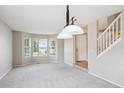 Spacious living room with large windows and plush carpeting at 9823 Salford Ln, Highlands Ranch, CO 80126