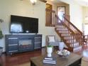 Living room showcasing a wooden staircase and a fireplace, perfect for relaxation and entertaining at 17671 E Brown Cir, Aurora, CO 80013