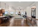 Open concept living area with fireplace and hardwood floors at 2794 Heron Lakes Pkwy, Berthoud, CO 80513