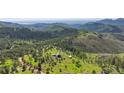 Scenic aerial view of a mountain home nestled in a lush forest setting at 393 Dixon Rd, Boulder, CO 80302