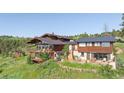 Beautiful home exterior with multi-level deck overlooking a landscaped yard at 393 Dixon Rd, Boulder, CO 80302