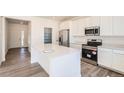 Modern kitchen features stainless steel appliances, a center island, and ample counter space at 10984 Snowdon St, Parker, CO 80134