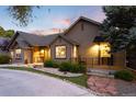 Charming single-story home featuring professional landscaping, decorative rock and inviting curb appeal at 1392 W Caley Ave, Littleton, CO 80120