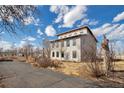 Unique two-story home featuring large windows and a modern roofline, set on a spacious lot at 13581 Sable Blvd, Brighton, CO 80601