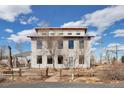 Contemporary two-story home showcasing large windows and modern design elements and fenced front yard at 13581 Sable Blvd, Brighton, CO 80601