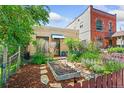 View of the home's exterior showcasing a garden, walkway, and lush landscaping at 34 W Maple Ave, Denver, CO 80223
