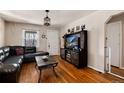 Cozy living room with hardwood floors, ample natural light, and a stylish entertainment center at 2754 S Sherman St, Englewood, CO 80113