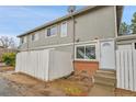 Exterior of a townhome with a private, fenced patio and small brick facade at 1344 Sable Blvd, Aurora, CO 80011