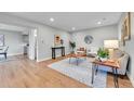 Bright living room features hardwood floors, recessed lighting, and stylish modern furniture at 1344 Sable Blvd, Aurora, CO 80011