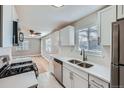 Modern kitchen with stainless steel appliances, white cabinets, and ample counter space at 382 S Decatur St, Denver, CO 80219