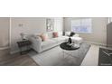 Bright living room featuring a modern sofa, stylish decor, and ample natural light at 382 S Decatur St, Denver, CO 80219