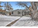 Gray house with black shutters, snowy front yard, and walkway at 2354 S Ogden St, Denver, CO 80210