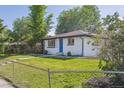Charming single story home featuring a well maintained lawn and blue front door at 6193 Holland St, Arvada, CO 80004