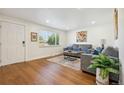 Cozy living room with hardwood floors, natural light, and comfortable seating at 6193 Holland St, Arvada, CO 80004