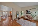 Bright living room featuring hardwood floors, neutral walls, and stylish decor with an open layout to the kitchen at 13472 Monroe St, Thornton, CO 80241