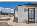 View of the home's front entrance with decorative security door at 851 S Umatilla Way, Denver, CO 80223