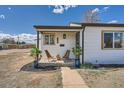 Charming covered porch with seating and decorative potted plants at 851 S Umatilla Way, Denver, CO 80223