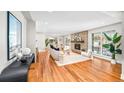 Open concept living room with hardwood floors and fireplace at 2775 E Dartmouth Ave, Denver, CO 80210