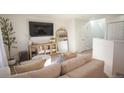 Beige sectional sofa dominates this living room, with TV and decorative items at 2245 E 103Rd Pl, Thornton, CO 80229