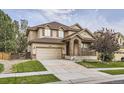 Two-story house with a brick facade, attached garage, and landscaping at 10288 Salida St, Commerce City, CO 80022