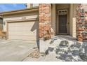 House entrance with brick columns, steps, and a double door at 10288 Salida St, Commerce City, CO 80022