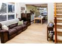 Spacious living area open to dining room, featuring hardwood floors and ample natural light at 17020 W 64Th Dr, Arvada, CO 80007