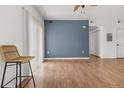 Spacious living room featuring hardwood floors, a blue accent wall, and an open layout at 1771 W 53Rd Pl # 1, Denver, CO 80221