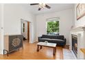 Bright living room featuring hardwood floors, fireplace, and a modern sofa with natural light at 2829 N Franklin St, Denver, CO 80205