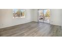 A spacious bright living room with new flooring and a sliding glass door to the balcony at 7755 E Quincy Ave # 301A2, Denver, CO 80237