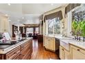 Spacious kitchen featuring a large island, stainless steel appliances, and hardwood floors at 3860 S Elkhart St, Aurora, CO 80014