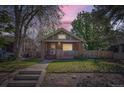 Charming brick bungalow with a welcoming front porch and well-maintained lawn at 2836 Cherry St, Denver, CO 80207