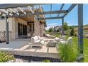 Relaxing outdoor patio with stone pillars, pergola, modern seating and beautiful views for entertaining at 3436 W 154Th Ave, Broomfield, CO 80023